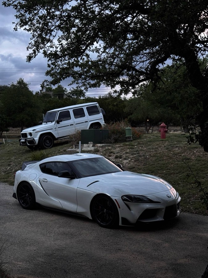 White Supra and G-Wagon at dusk